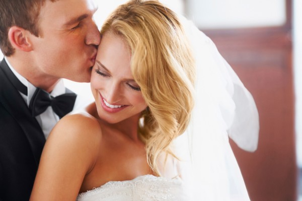 Groom kissing bridge
