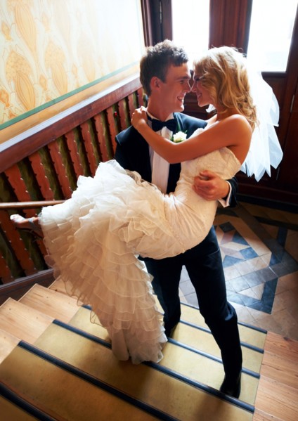 Groom carrying bride