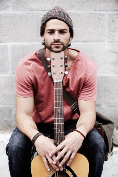 Portrait of musician against brick wall