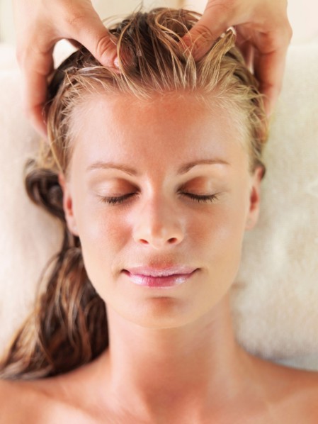 Mid adult woman receiving head massage