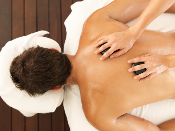 Man getting stone massage in spa