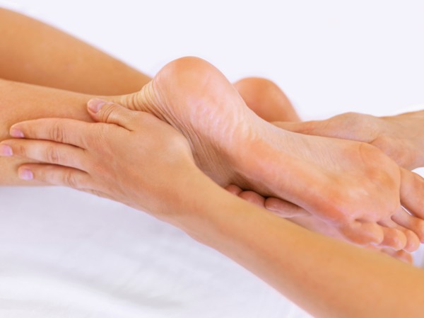 Hand massaging feet