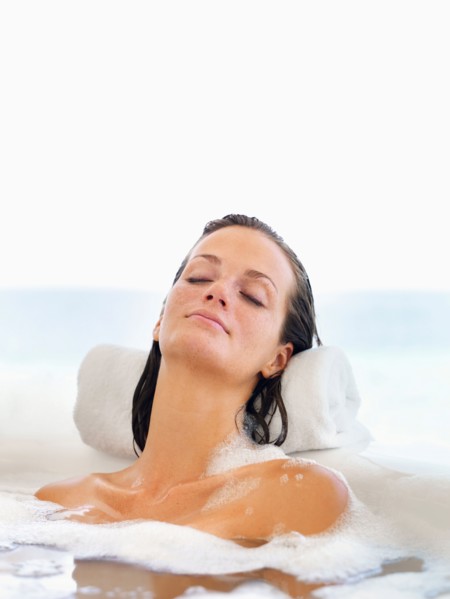 Woman relaxing in bathtub