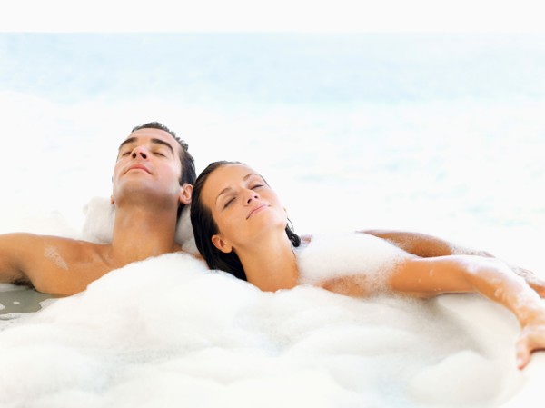 Couple relaxing in bathtub