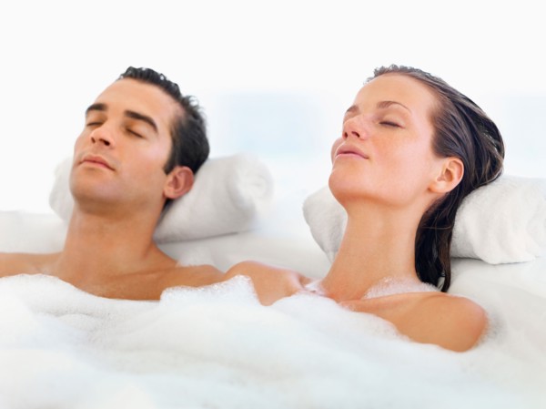 Couple relaxing in bathtub