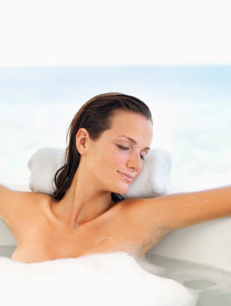 Woman relaxing in bathtub