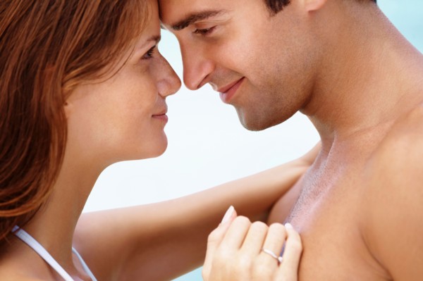 Young attractive couple enjoying summer holiday on beach