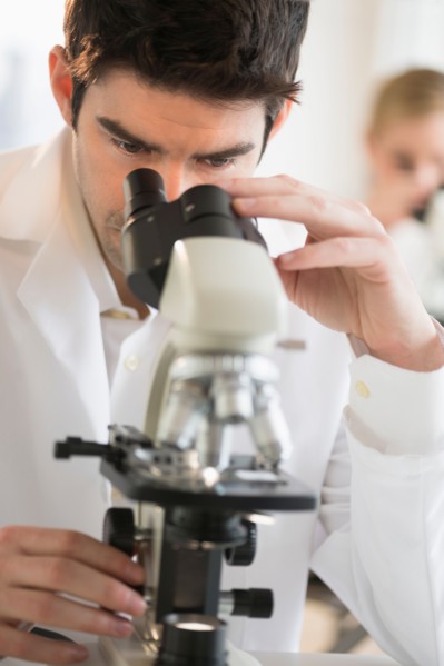 Scientist doing research on microscopes.