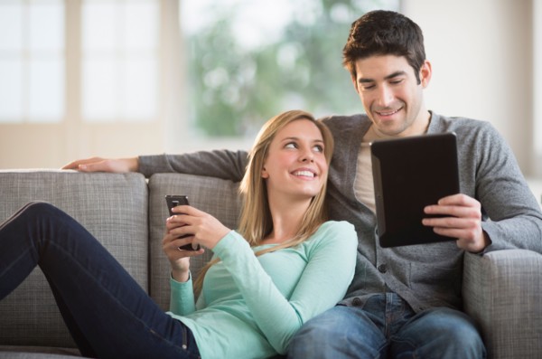 Couple using tablet pc and smartphone.