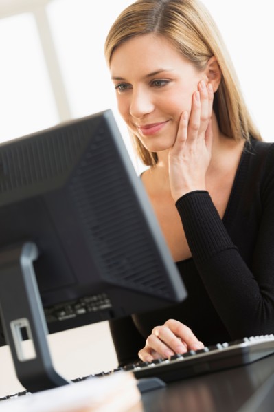 Business woman looking at computer.