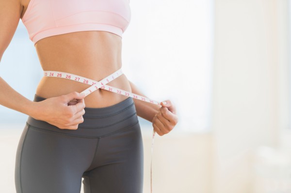 Woman measuring waist.