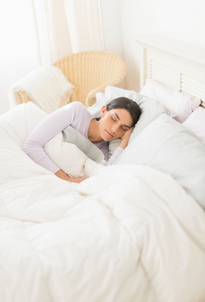 Woman sleeping in bed.