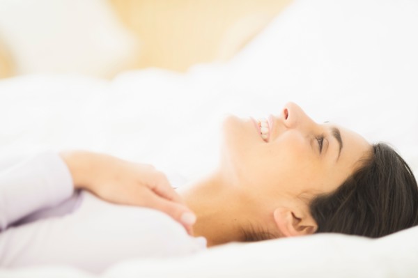 Woman lying in bed.
