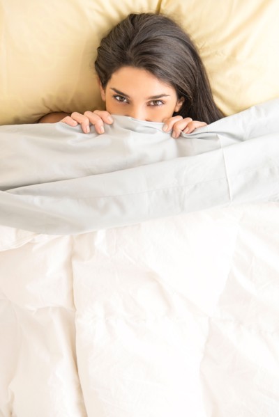 Woman lying in bed.