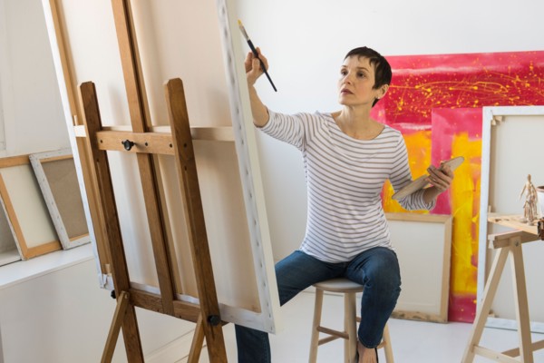 Female artist painting in her studio.