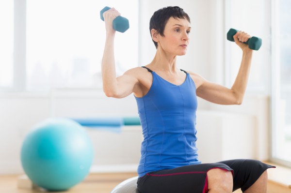 Mature woman exercising in gym.
