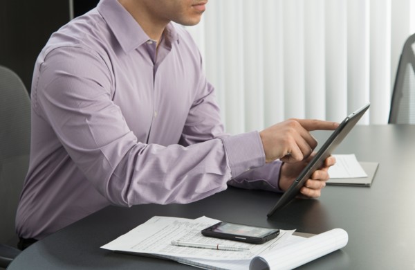 Male executive working at desk in office.