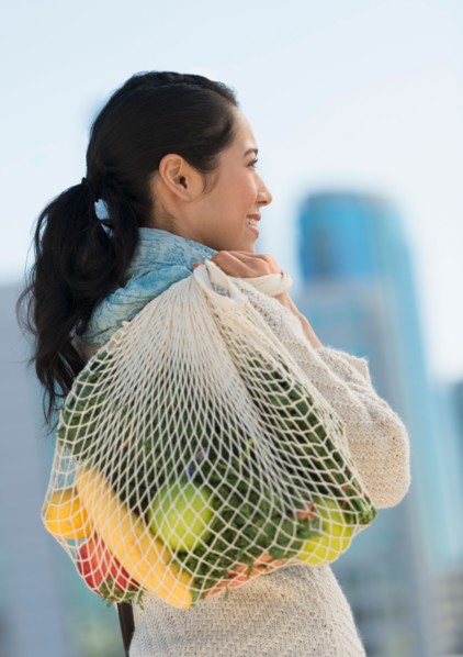 Young woman with grocery shopping bag.