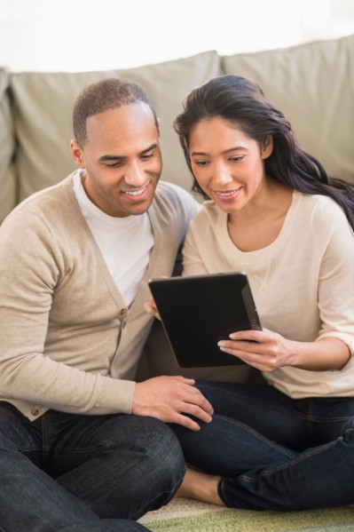 Young couple using digital tablets.