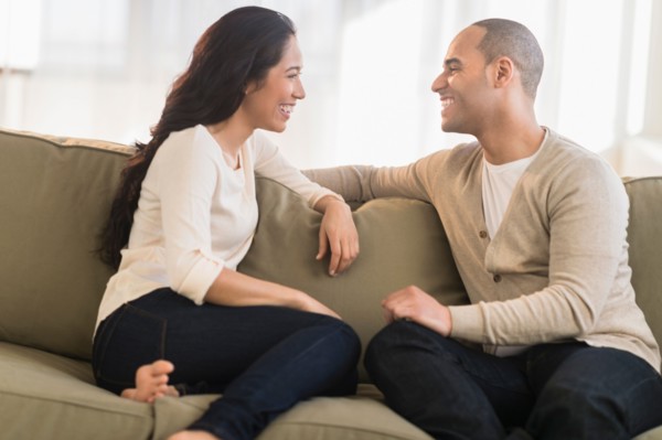 Portrait of young couple sitting on couch.