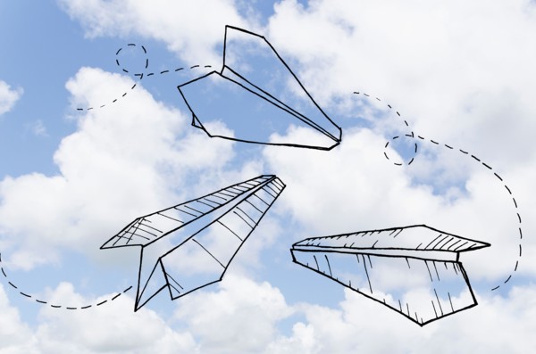 Paperplanes drawn on cloudy sky