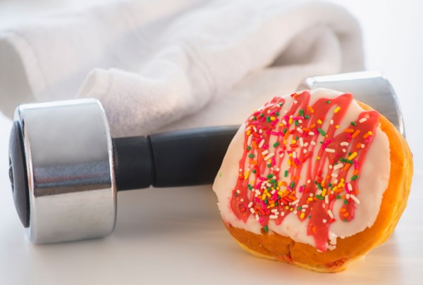 Studio Shot of jelly doughnut and hand weight