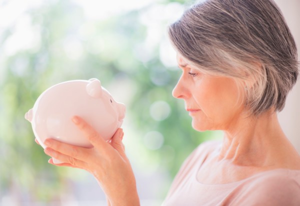 Portrait of woman holding piggy bank