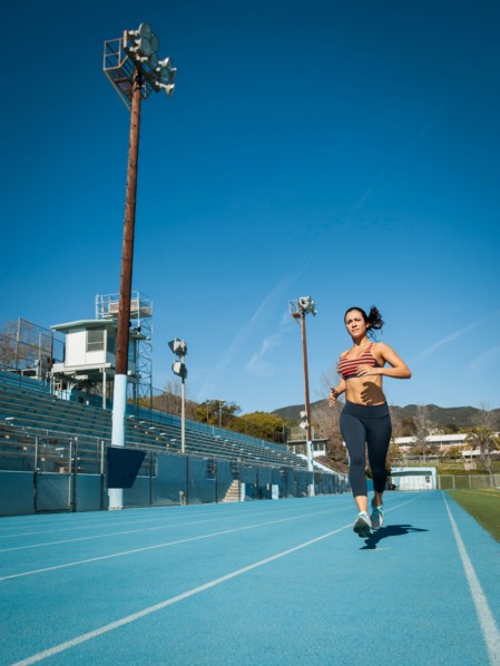 Woman running at sports field
