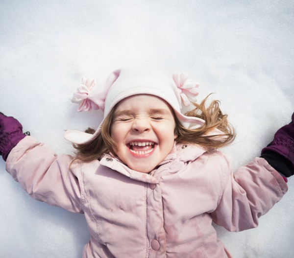 Portrait of Girl (2-3) lying down on snow