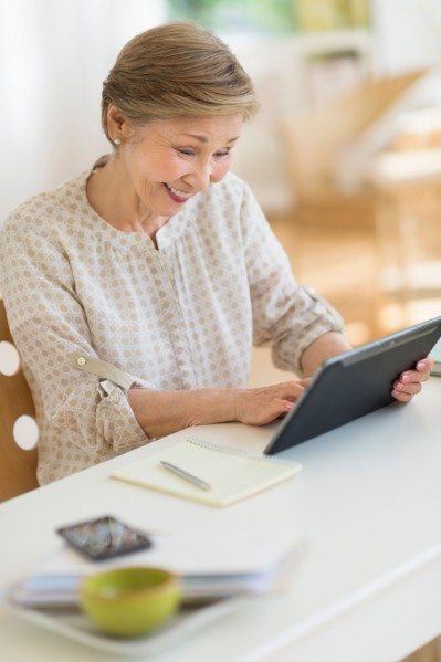 Senior woman using tablet pc at home.
