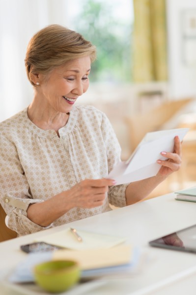 Senior woman reading letter.