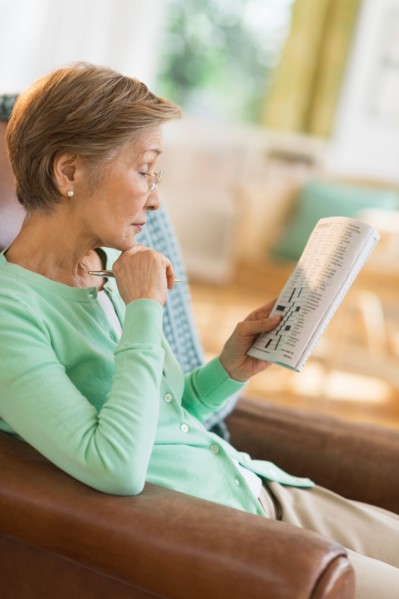 Senior woman doing crossword puzzle.