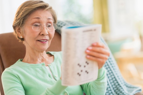 Senior woman doing crossword puzzle.