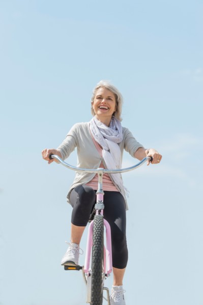 Senior woman riding bicycle.