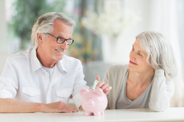Senior couple with piggybank.
