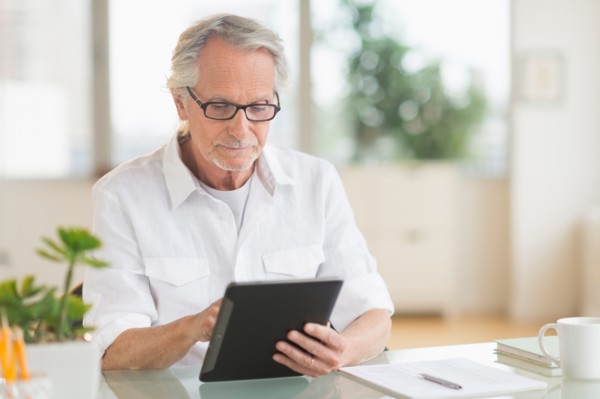 Senior man using digital tablet.