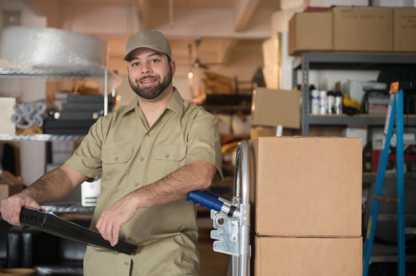 Portrait of delivery man in warehouse