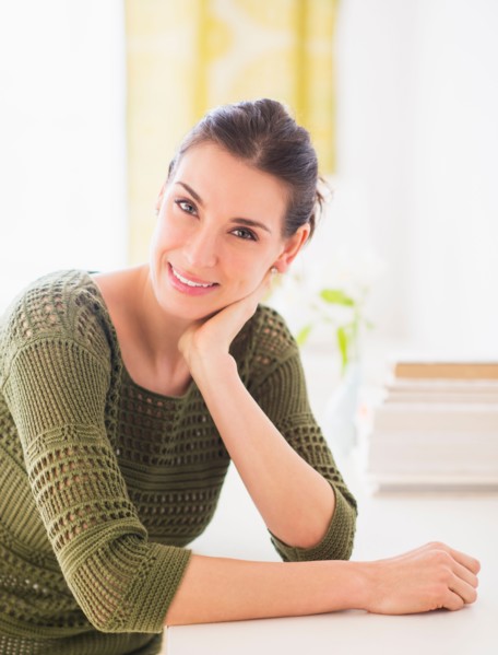 Portrait of happy woman sitting at table