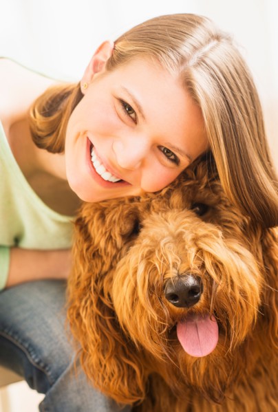 Young cheerful woman with her dog