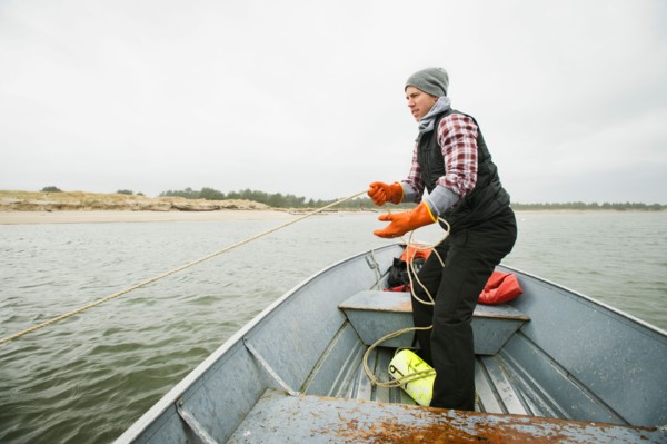 Man pulling net full of crabs