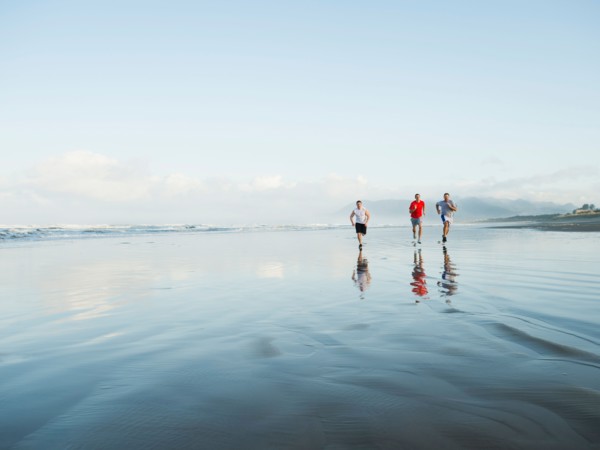 Men running on beach