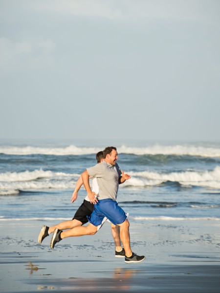 Men running on beach