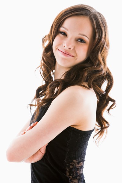 Portrait of smiling girl (12-13) with arms crossed