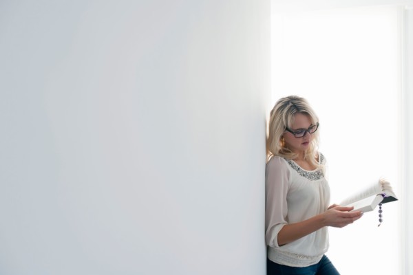 Woman reading book indoors