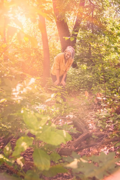 Central Park, New York City. Senior woman hiking in sunny forest.
