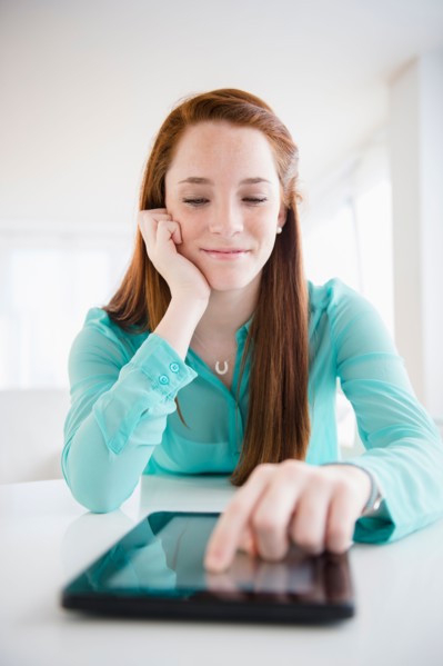 Teenage girl (14-15) using digital tablet