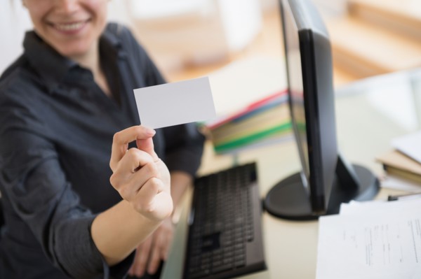 Young woman showing blank business card