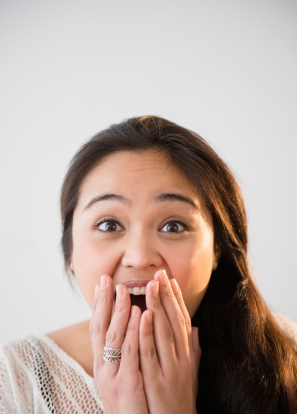 Studio shot of beautiful young woman laughing