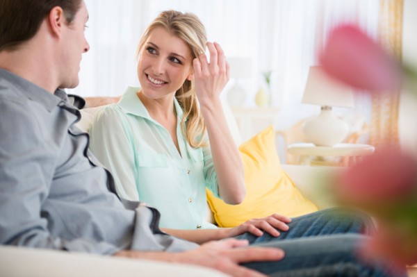 Couple talking on sofa