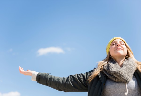 Young woman under blue sky